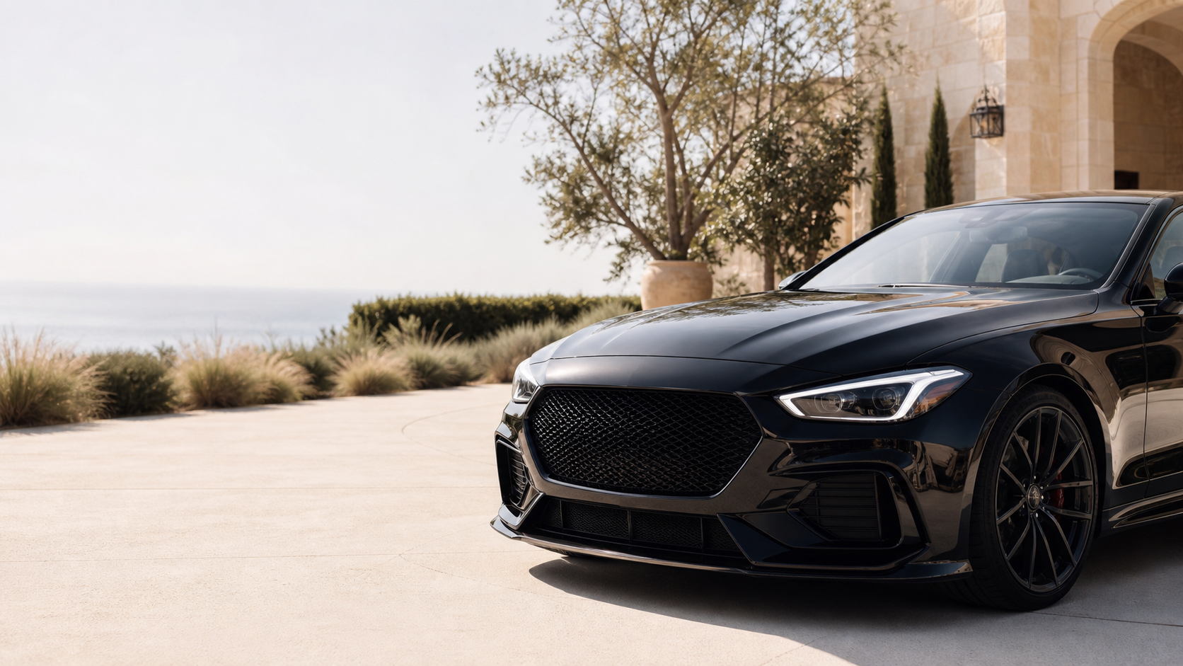 Black luxury sedan at a Southern California coastal residence
